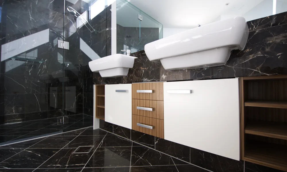 Dark stone tiled bathroom from C and K Tiling's published gallery